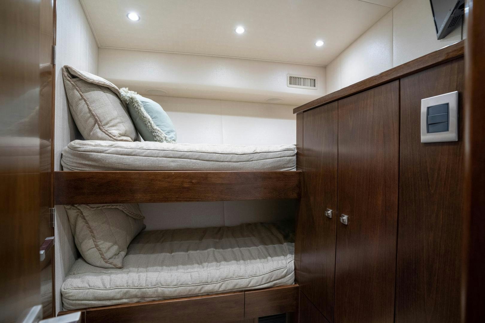 a bed with a wooden headboard aboard MER SEA SAKES Yacht for Sale