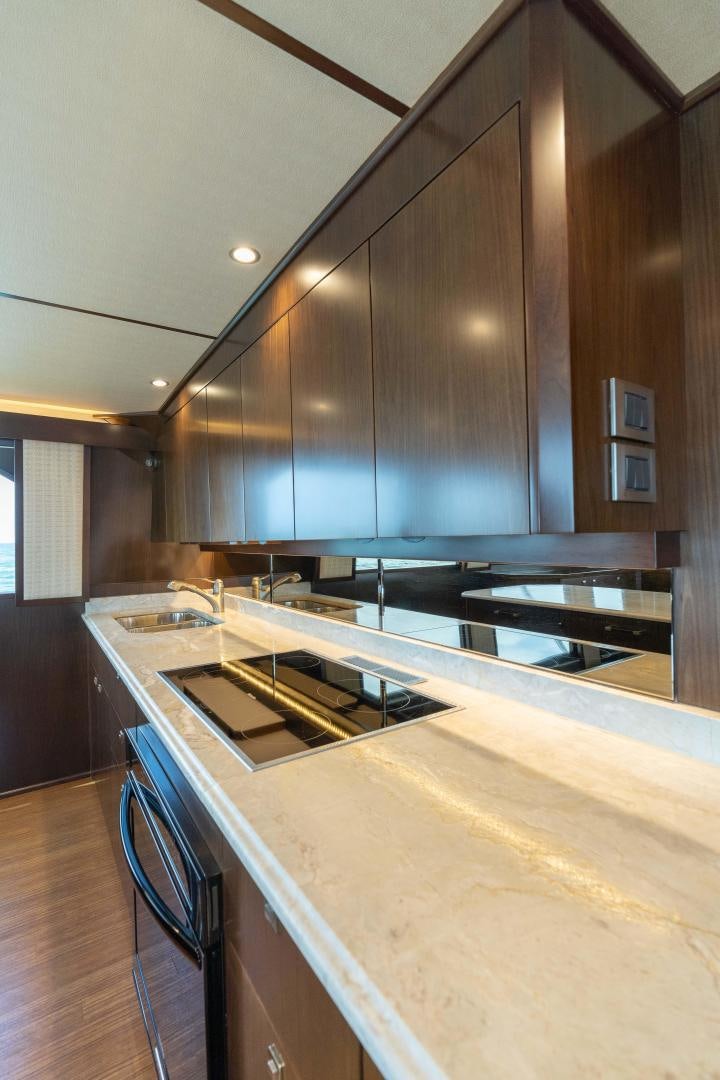 a kitchen with a large island aboard MER SEA SAKES Yacht for Sale
