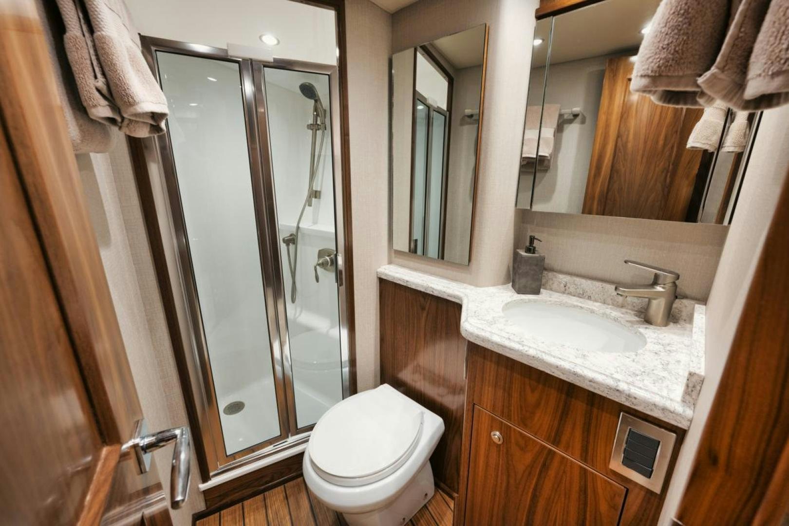 a bathroom with a glass shower door aboard MADNIC Yacht for Sale