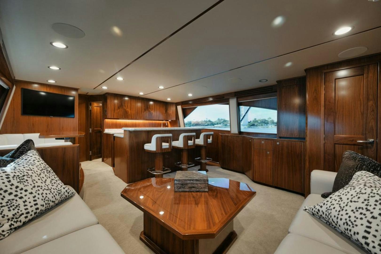 a living room with a wood table aboard MADNIC Yacht for Sale
