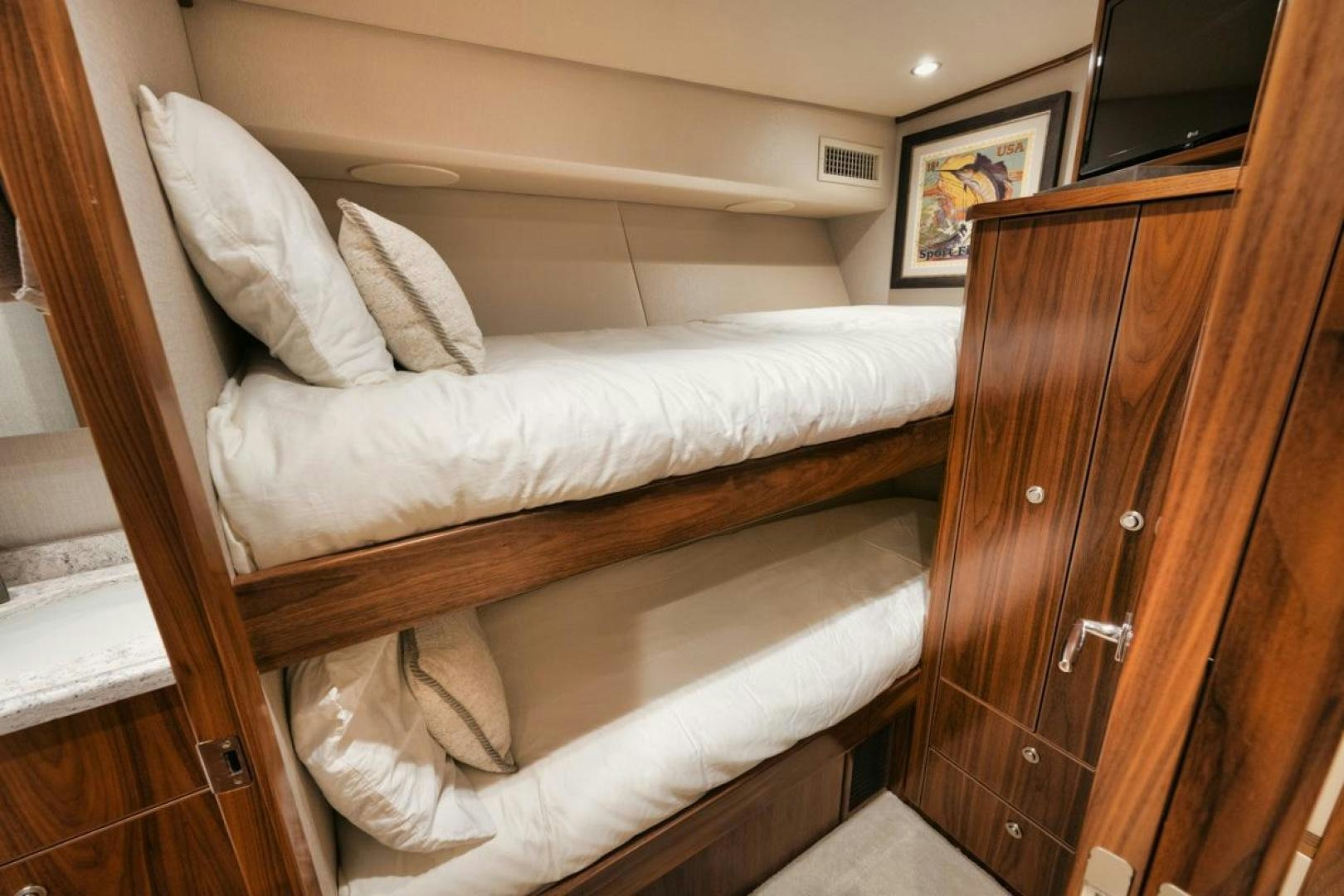 a bed with white sheets aboard MADNIC Yacht for Sale