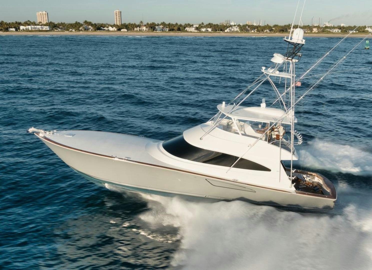 a white boat on the water aboard MADNIC Yacht for Sale