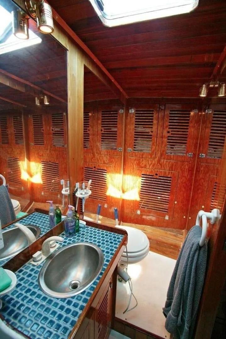 a bathroom with a sink and a mirror aboard CHRISTINE Yacht for Sale