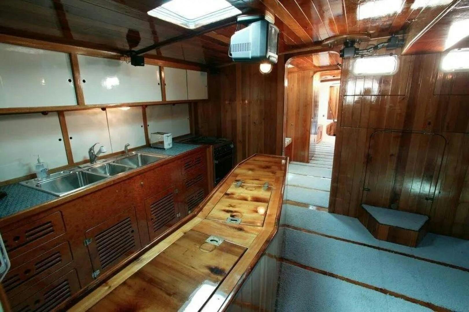 a kitchen with wooden cabinets aboard CHRISTINE Yacht for Sale