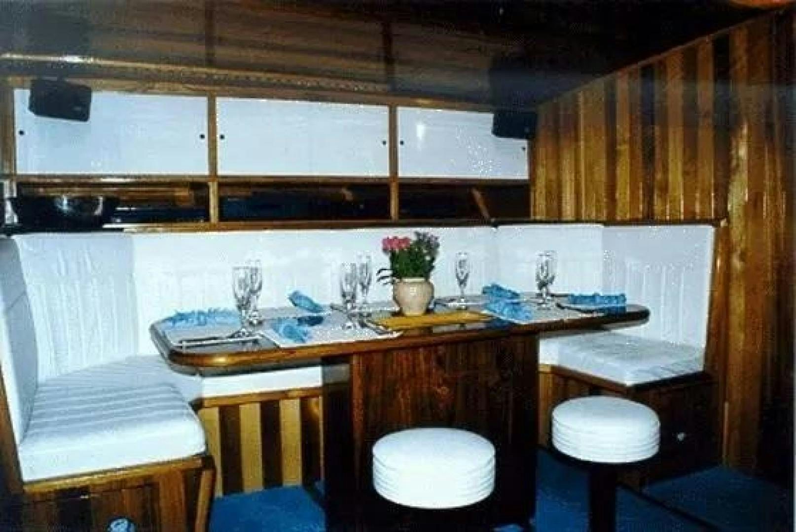 a kitchen with a table and chairs aboard CHRISTINE Yacht for Sale