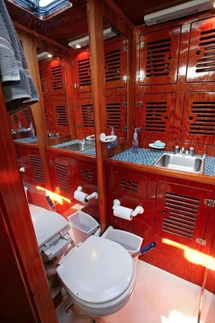 a bathroom with a toilet and sink aboard CHRISTINE Yacht for Sale