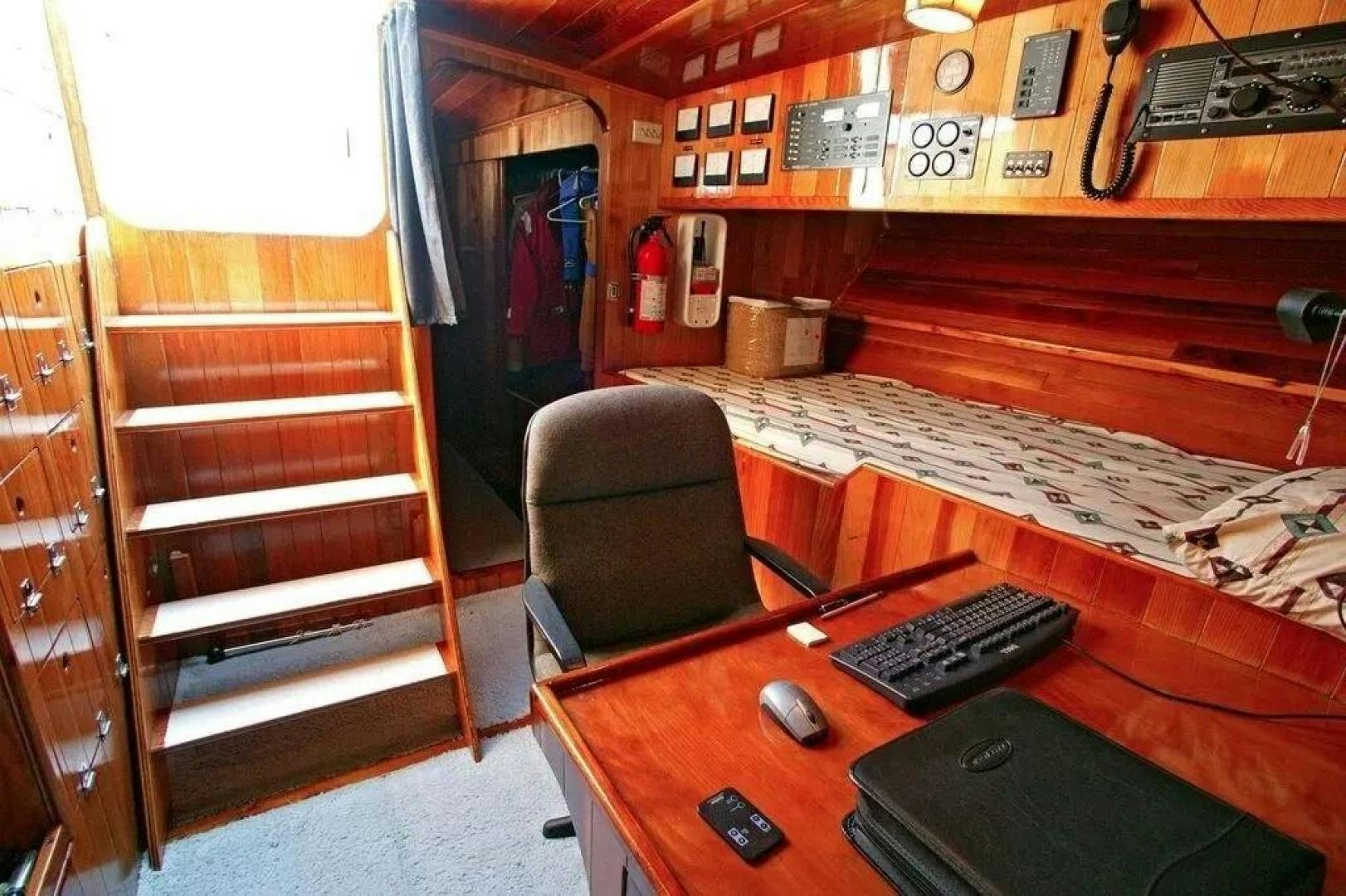 a desk with a computer and a keyboard on it aboard CHRISTINE Yacht for Sale