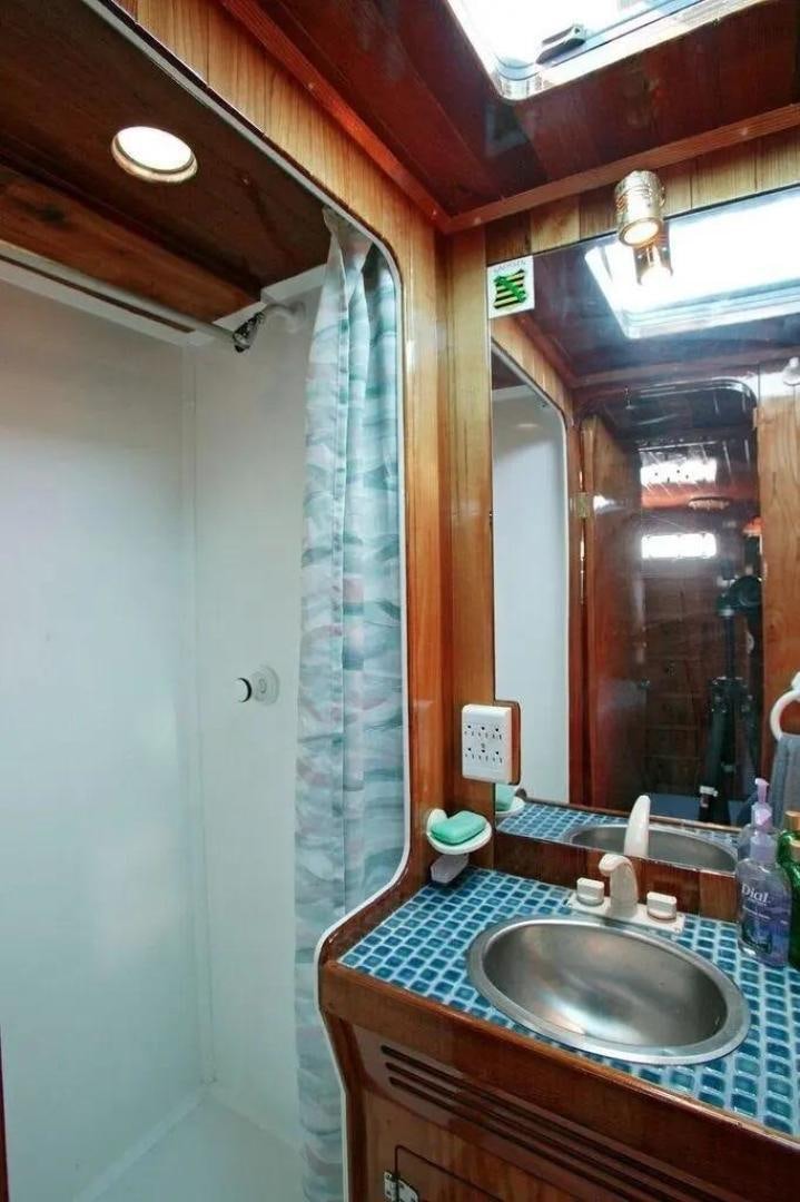 a bathroom with a sink and a mirror aboard CHRISTINE Yacht for Sale