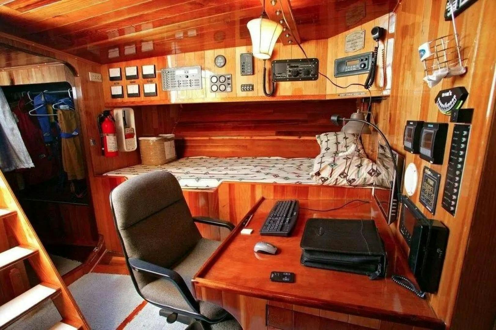 a desk with a computer and a chair aboard CHRISTINE Yacht for Sale