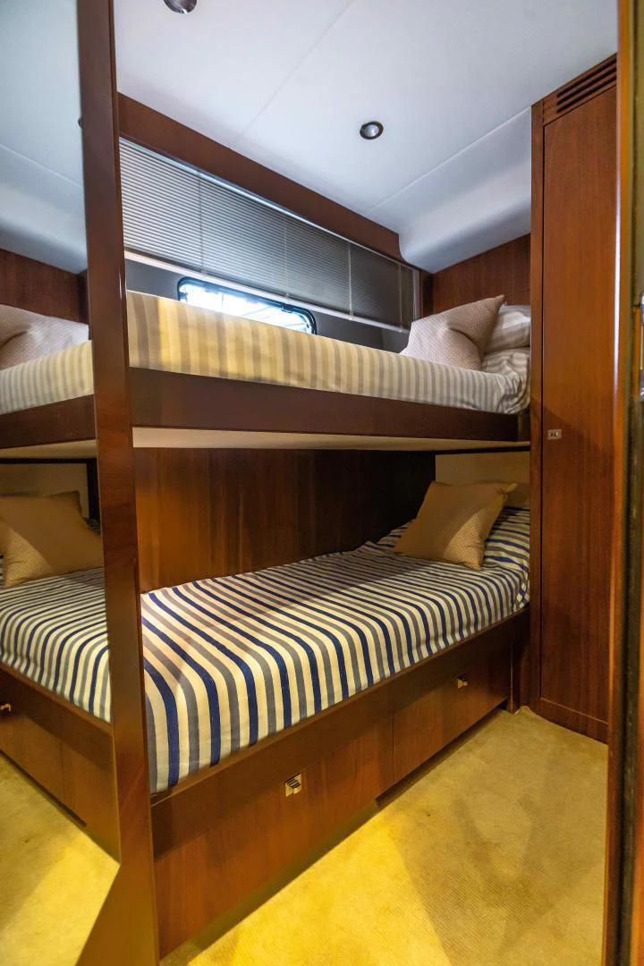 a bunk bed with a wood headboard aboard CAPE COD Yacht for Sale