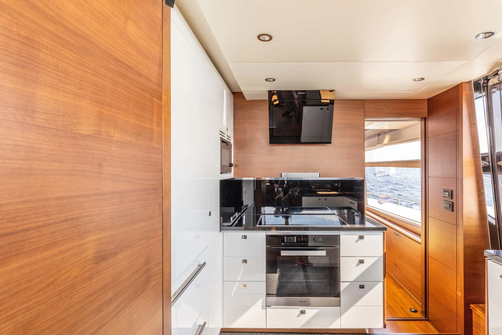 a kitchen with a stove and microwave aboard CAPE COD Yacht for Sale