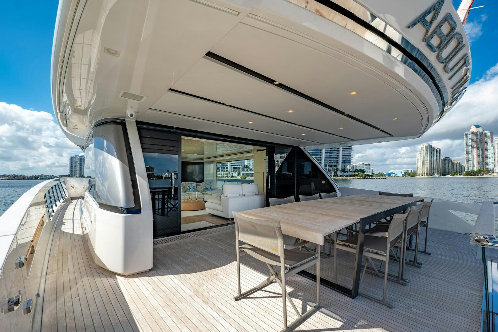 a deck with a table and chairs on it aboard ABOUT TIME Yacht for Sale