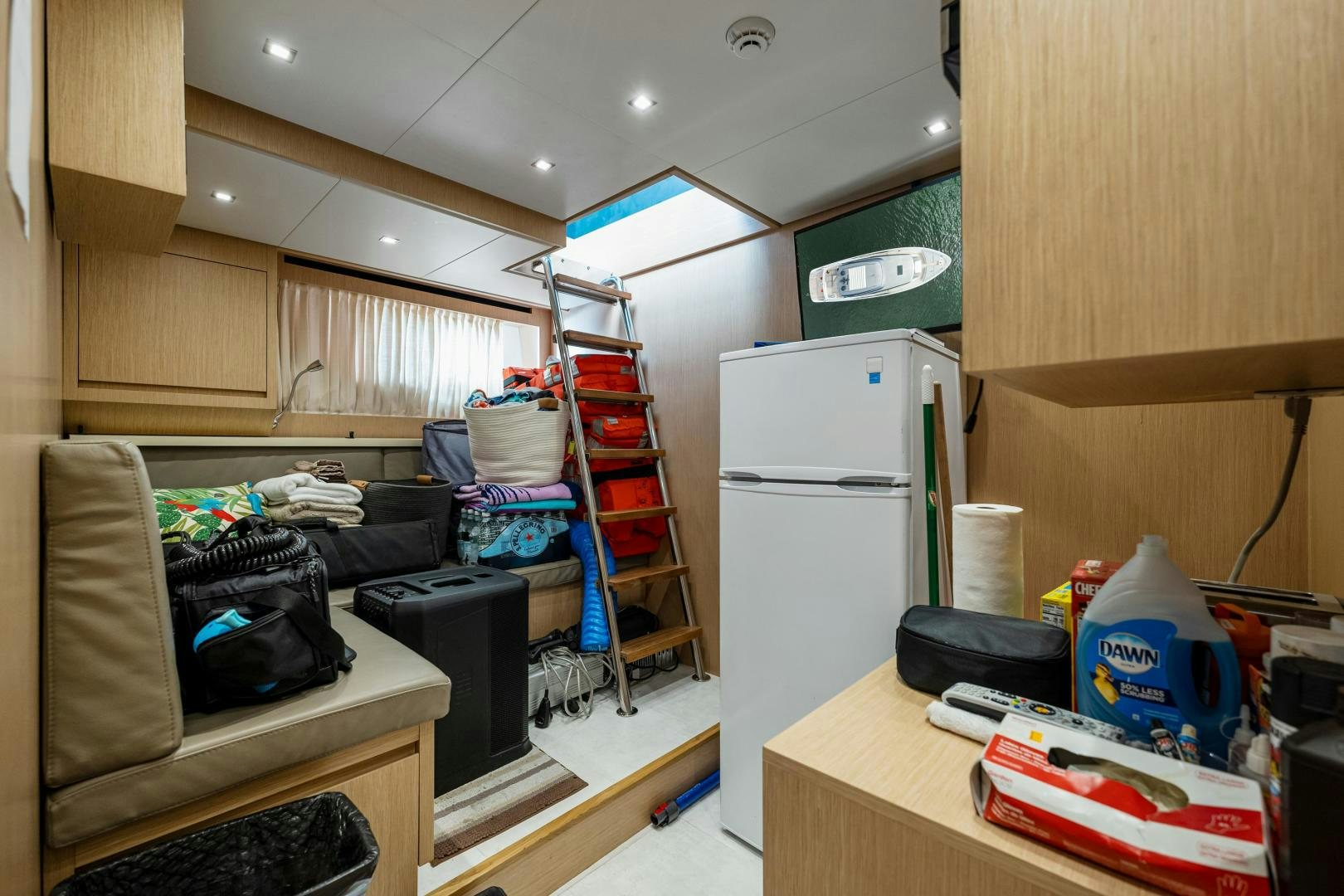 a room with a ladder and a bed aboard ABOUT TIME Yacht for Sale