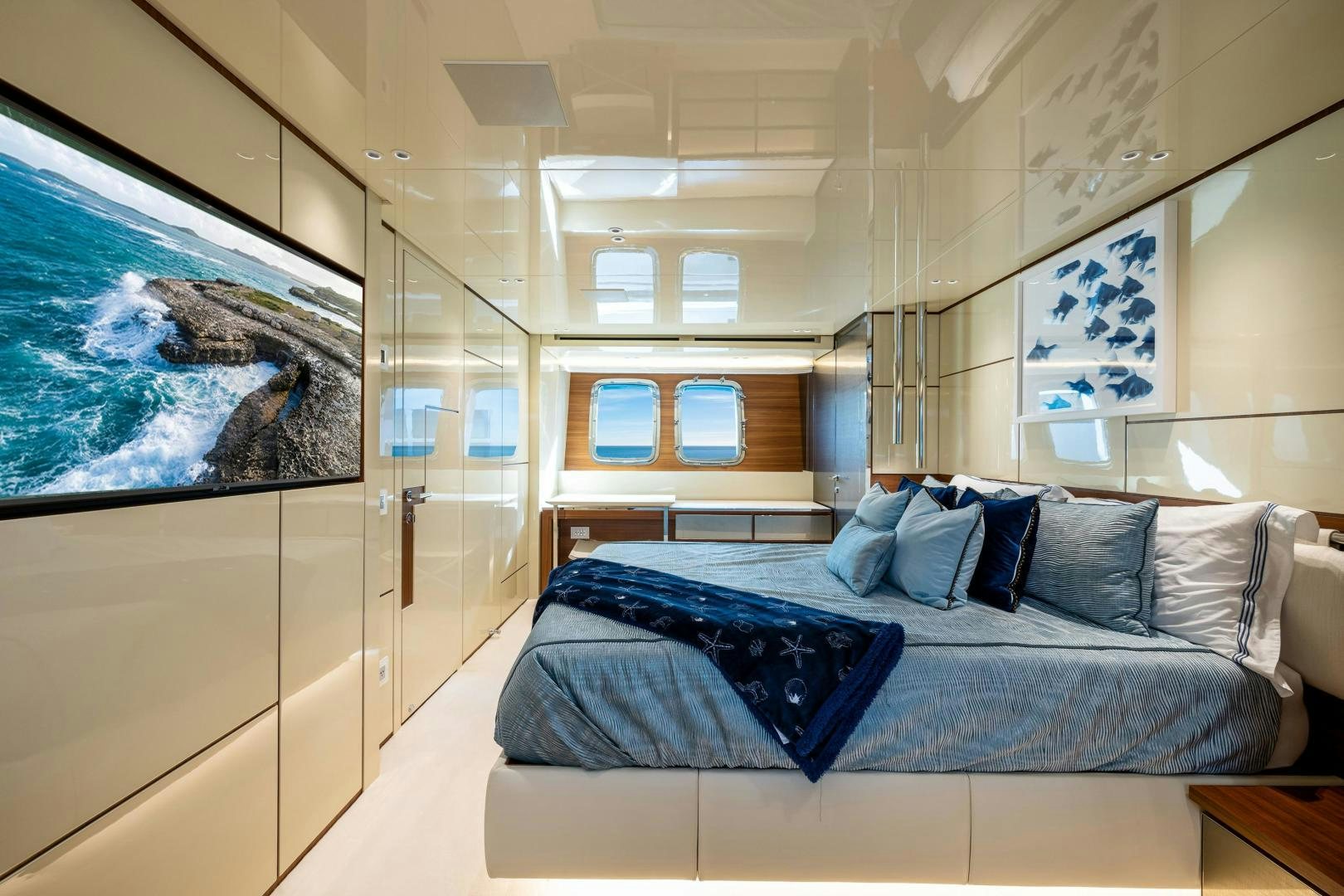 a room with a bed and a painting on the wall aboard ABOUT TIME Yacht for Sale