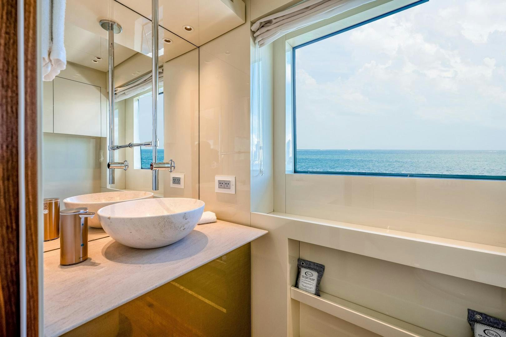 a bathroom with a sink and a window aboard ABOUT TIME Yacht for Sale