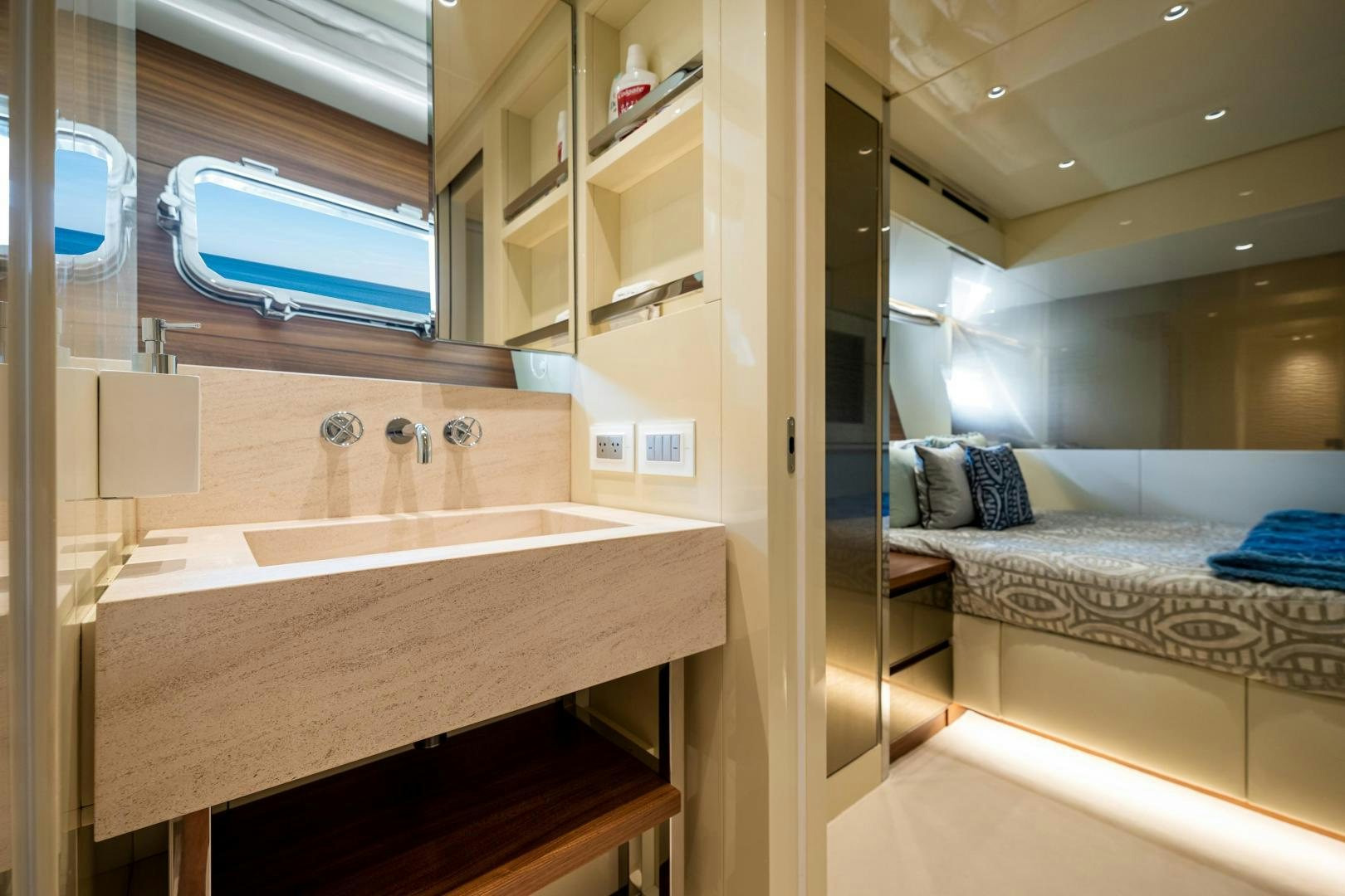 a bathroom with a sink and a bed aboard ABOUT TIME Yacht for Sale