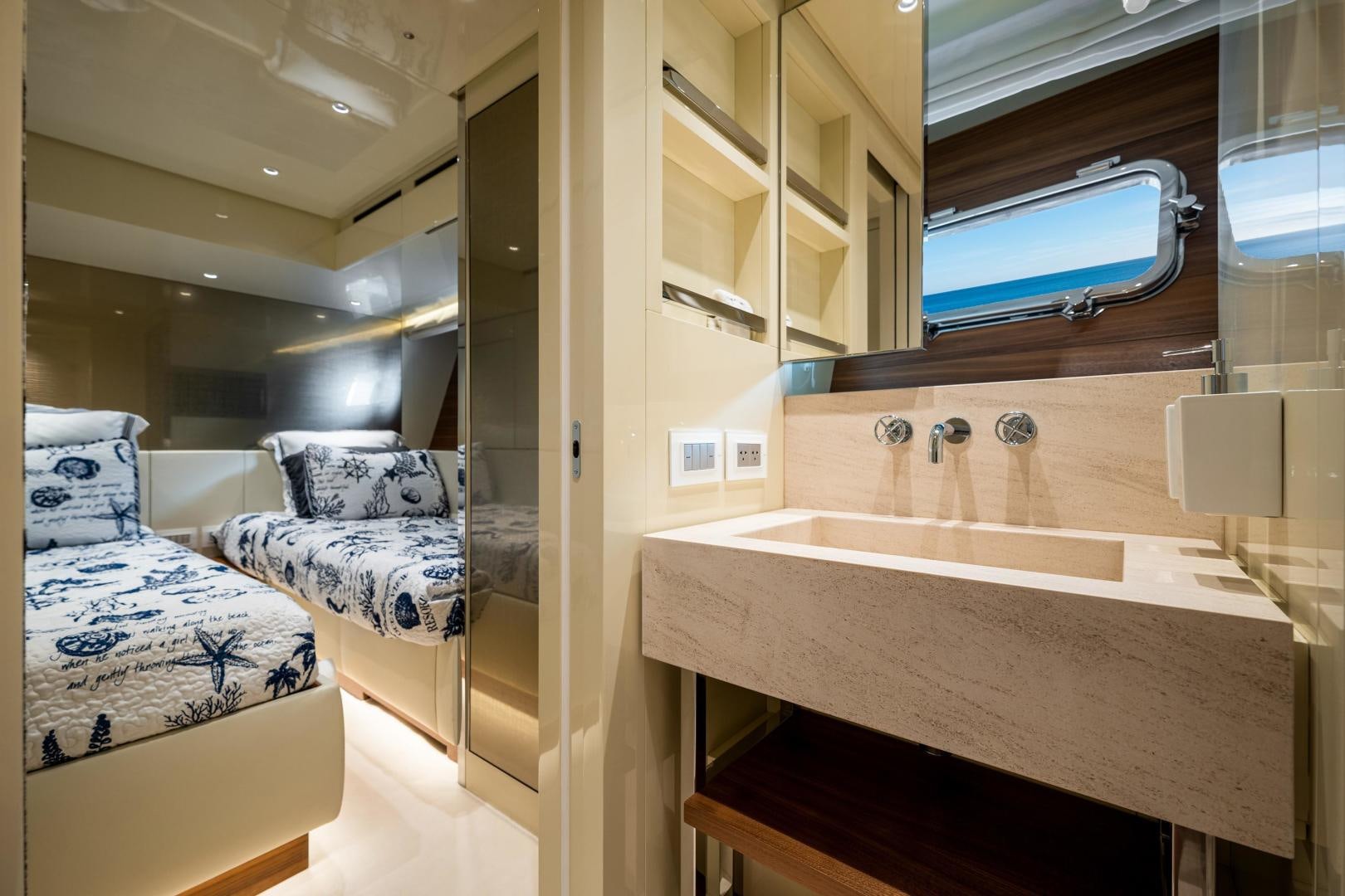 a small bedroom with a bed and a sink aboard ABOUT TIME Yacht for Sale