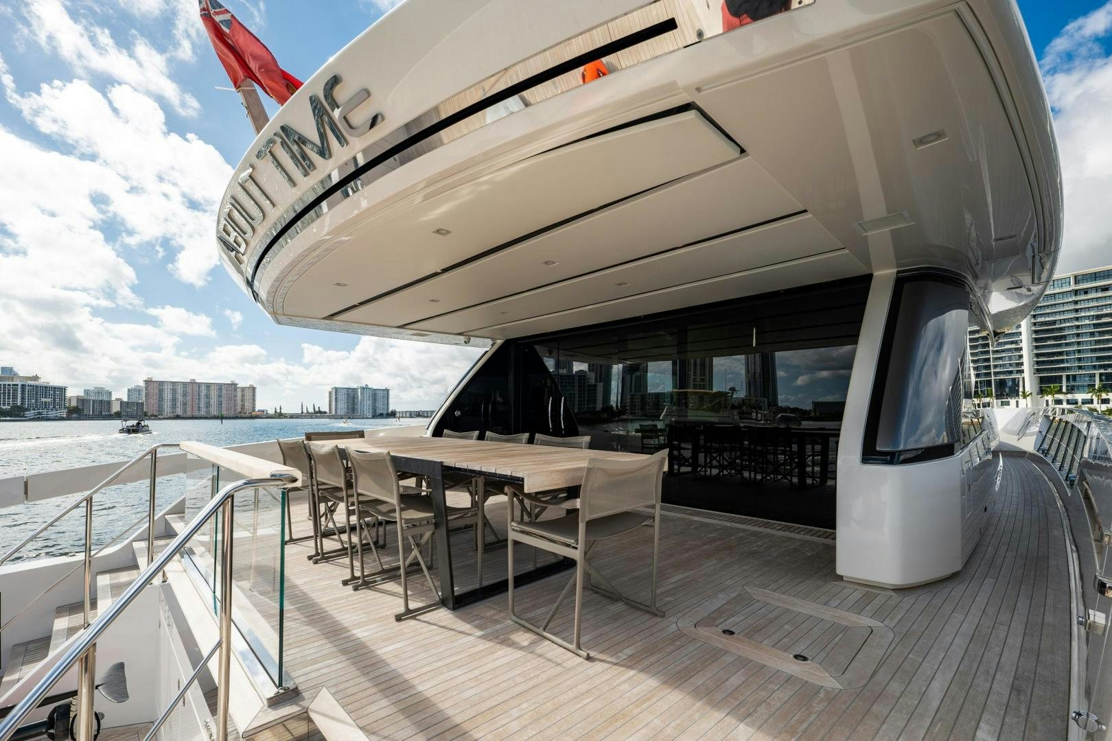 a deck with a table and chairs on it aboard ABOUT TIME Yacht for Sale
