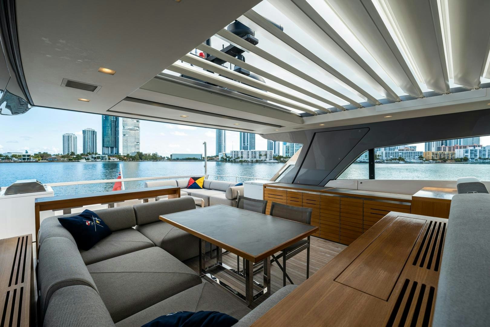 a room with a couch and a table and a view of a city aboard ABOUT TIME Yacht for Sale