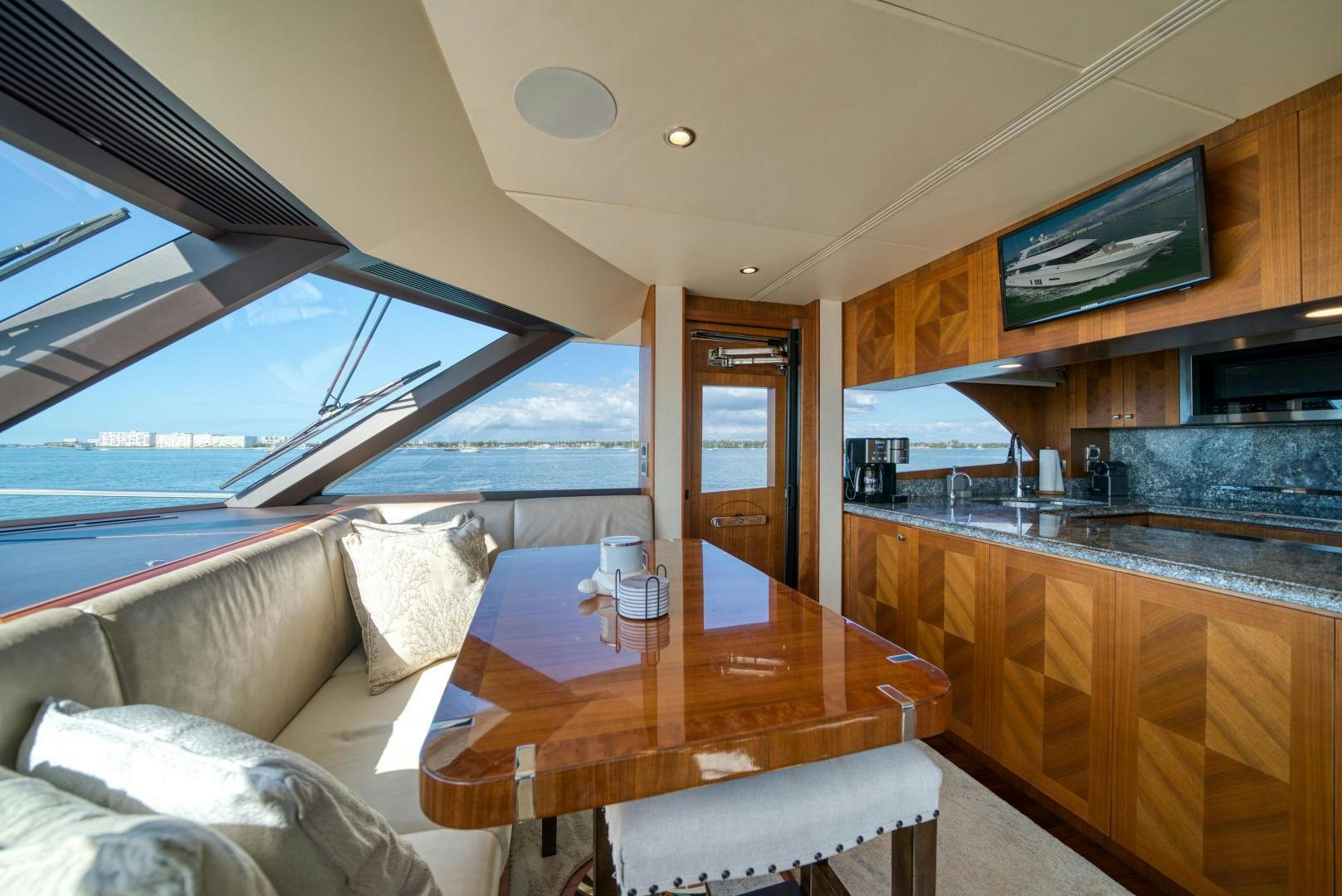 a living room with a table and couches aboard SANCTUARY Yacht for Sale