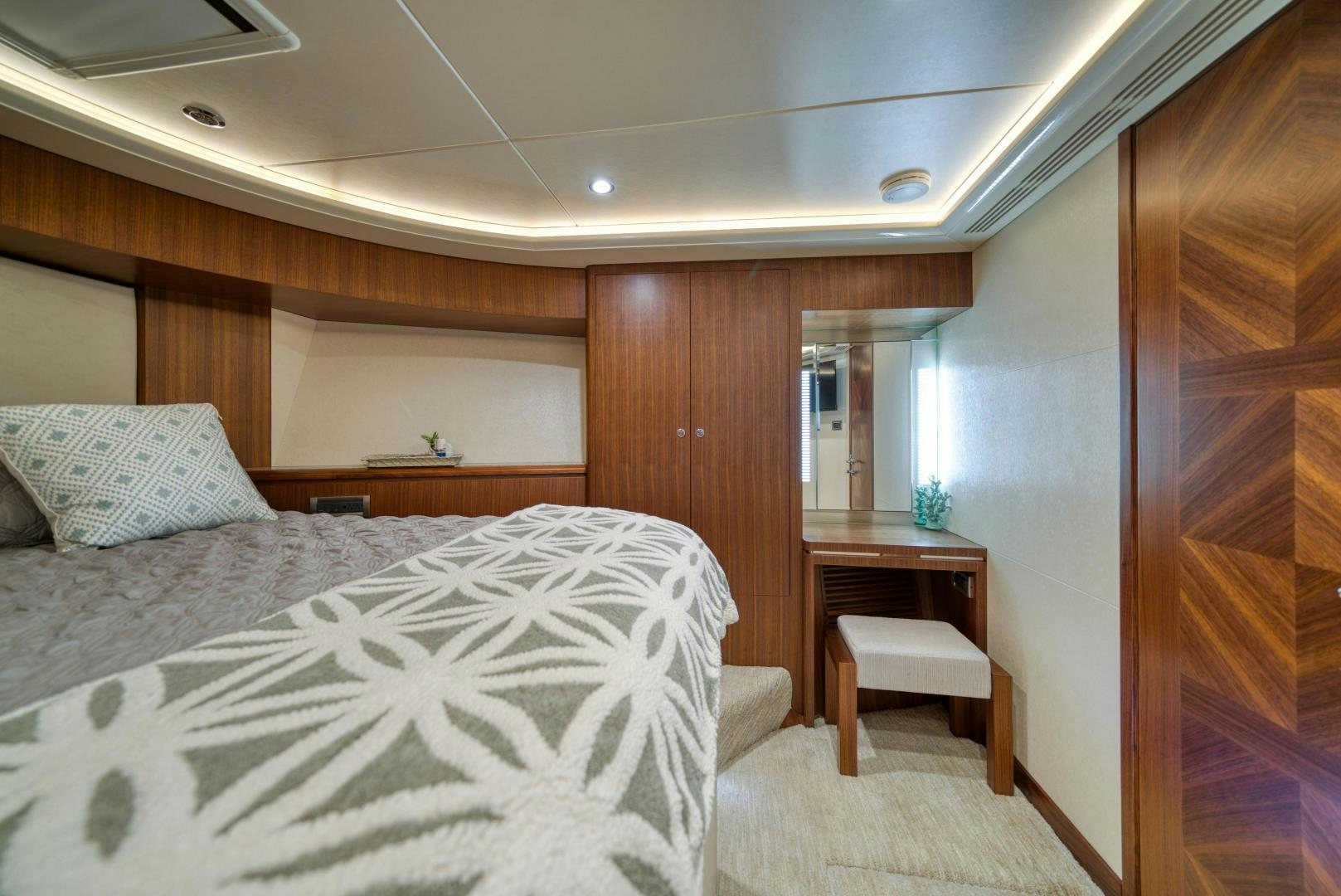 a bedroom with a bed and a desk aboard SANCTUARY Yacht for Sale