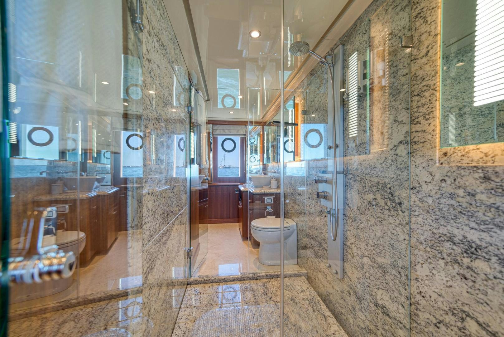 a bathroom with a glass shower aboard SANCTUARY Yacht for Sale