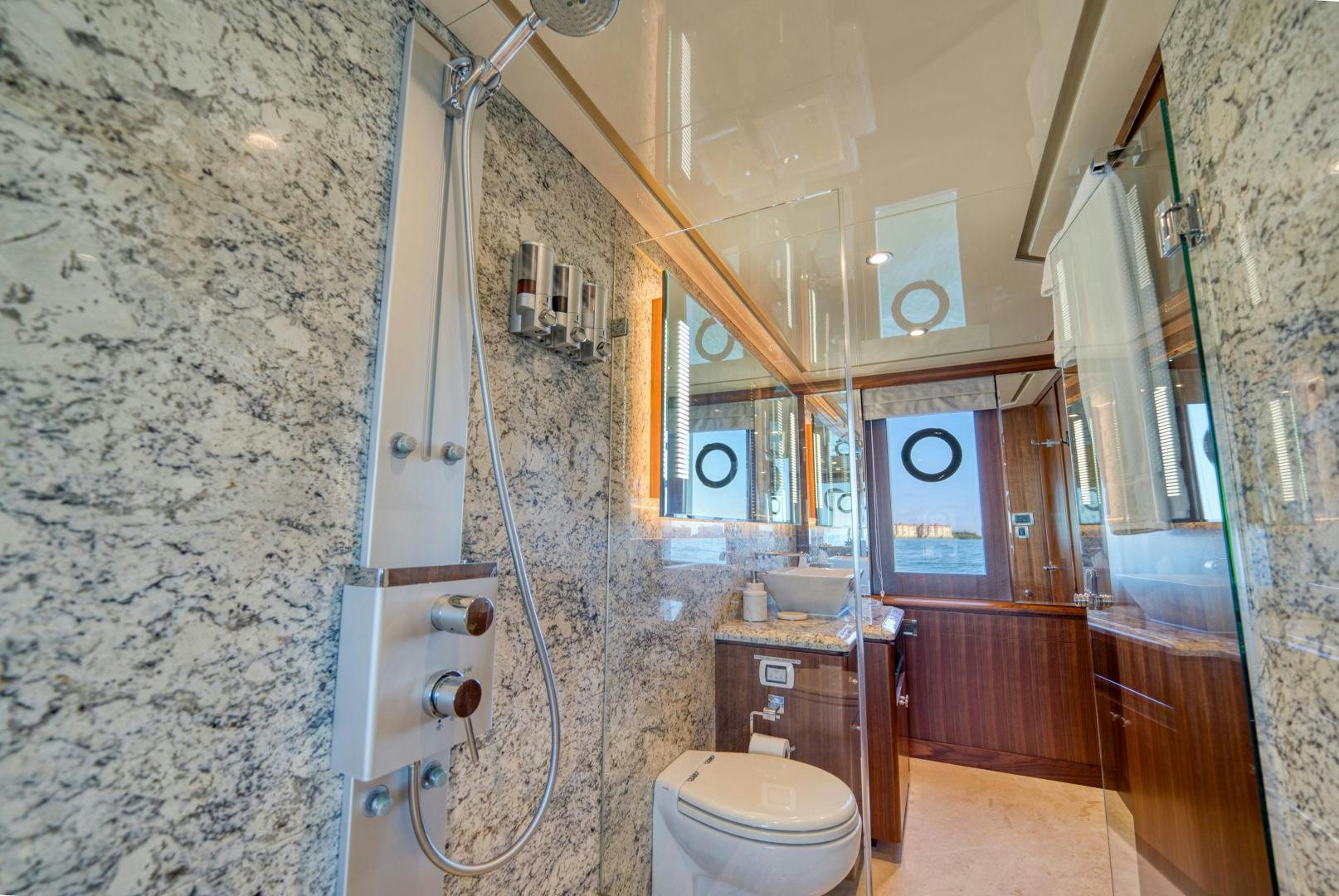 a bathroom with a shower unit and toilet aboard SANCTUARY Yacht for Sale