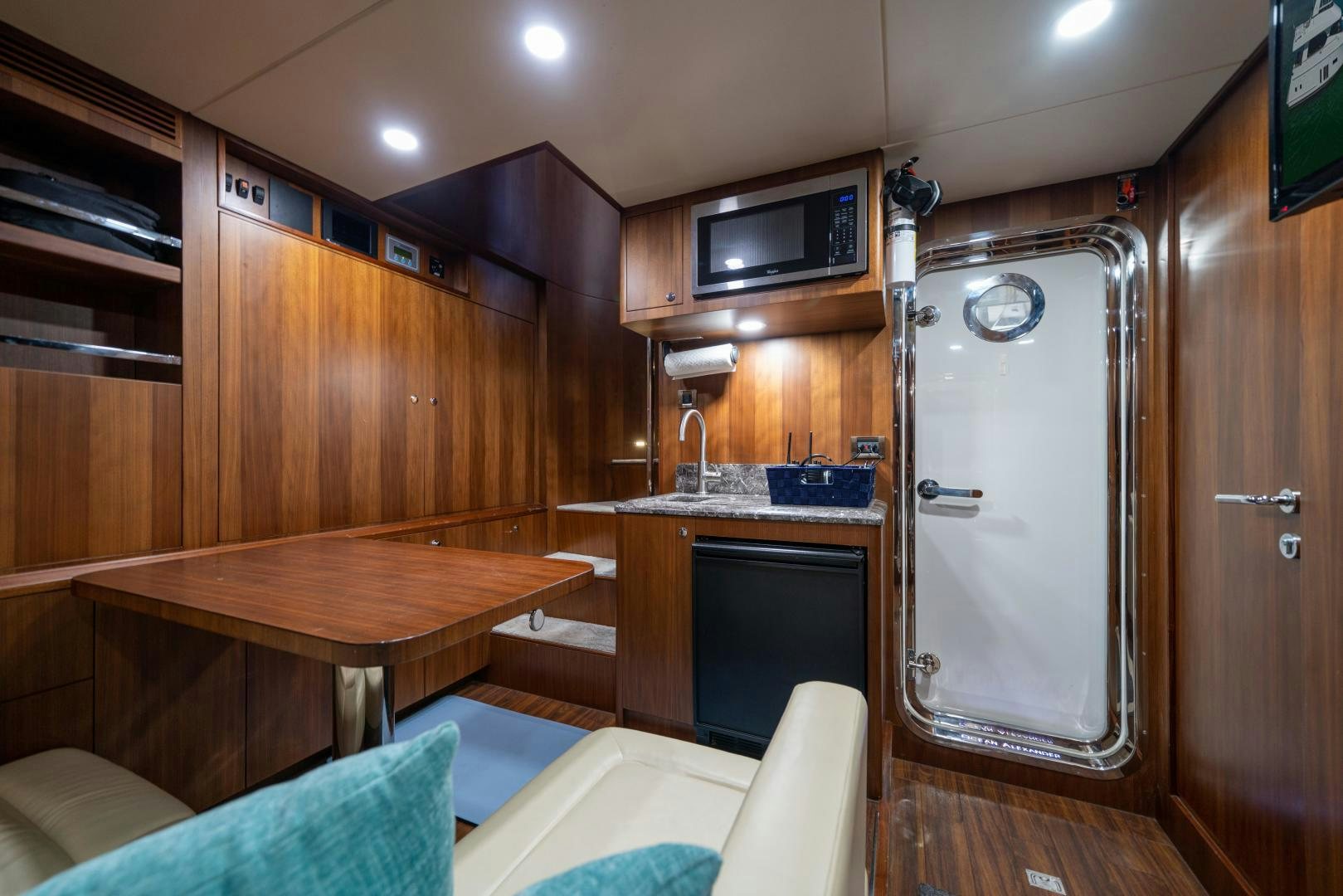 a room with a table and a tv aboard SANCTUARY Yacht for Sale