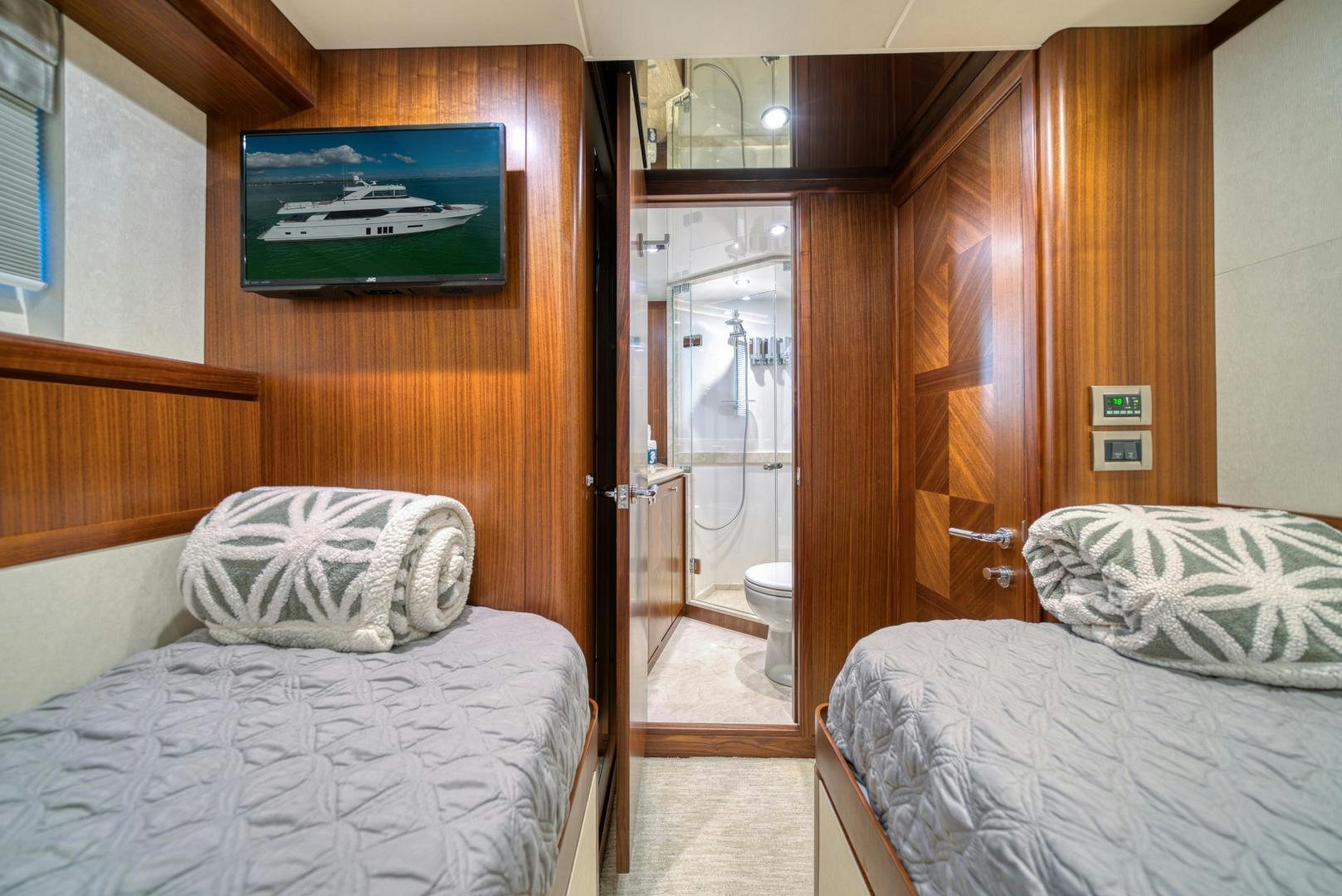 a room with a bed and a door aboard SANCTUARY Yacht for Sale