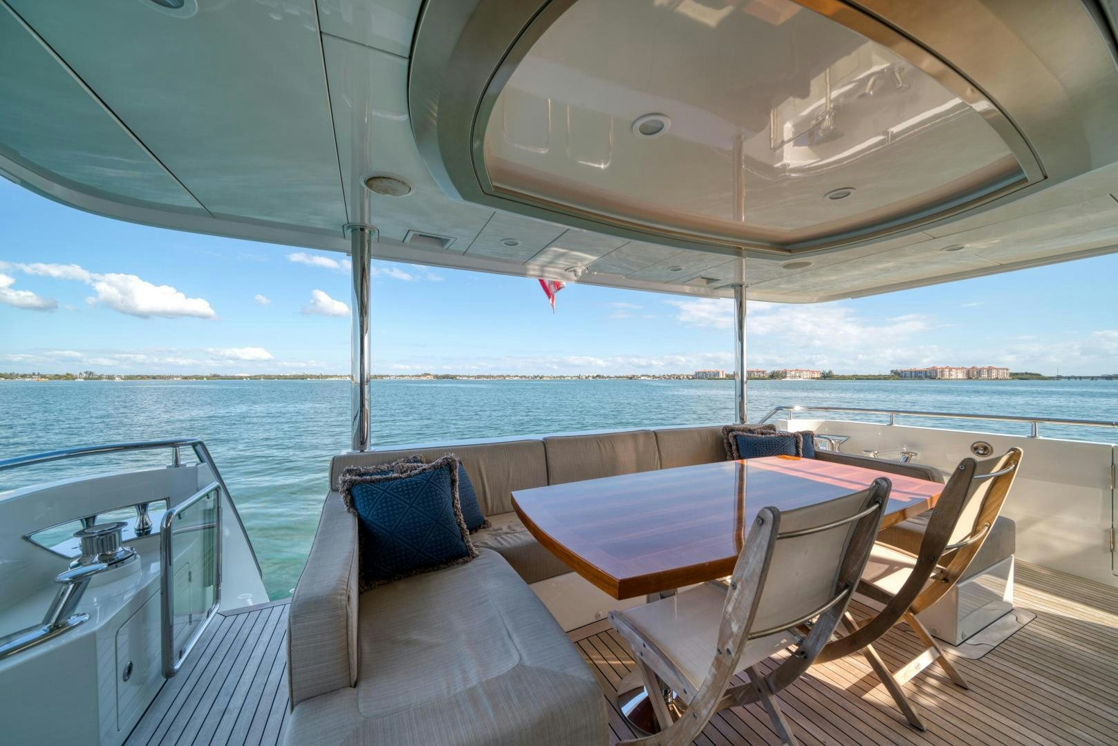 a deck with chairs and a table on it aboard SANCTUARY Yacht for Sale