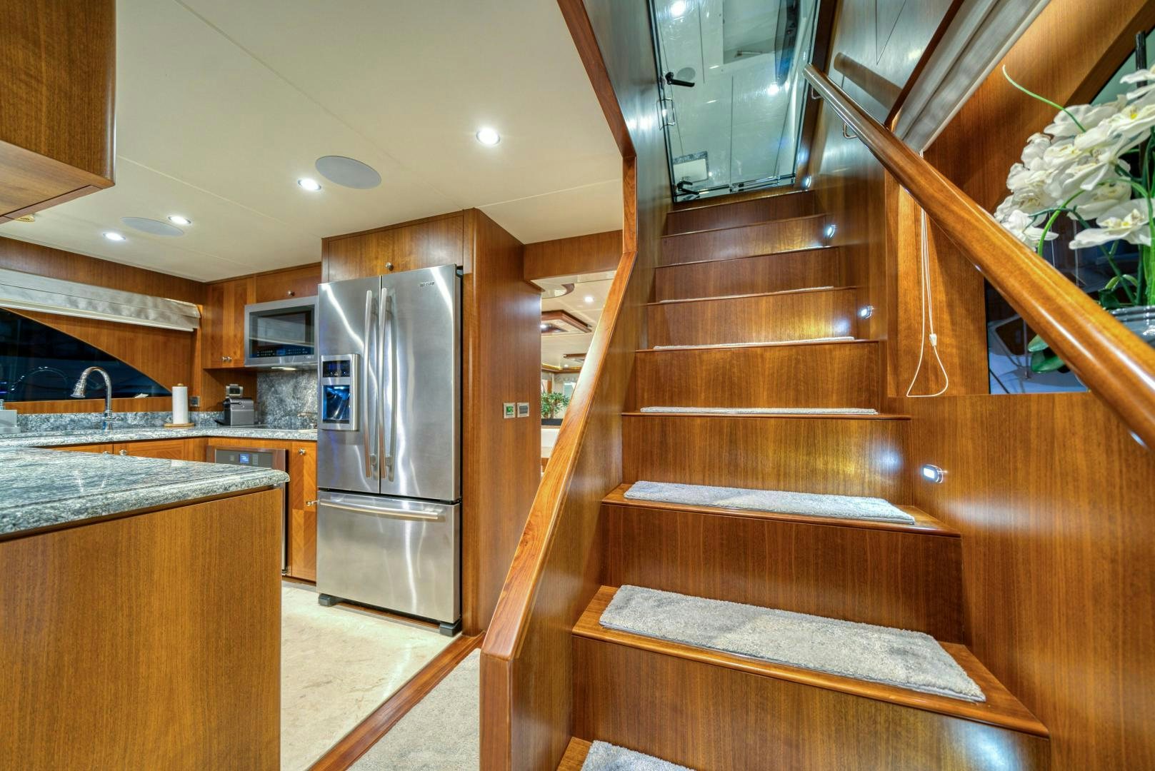 a kitchen with wooden cabinets aboard SANCTUARY Yacht for Sale