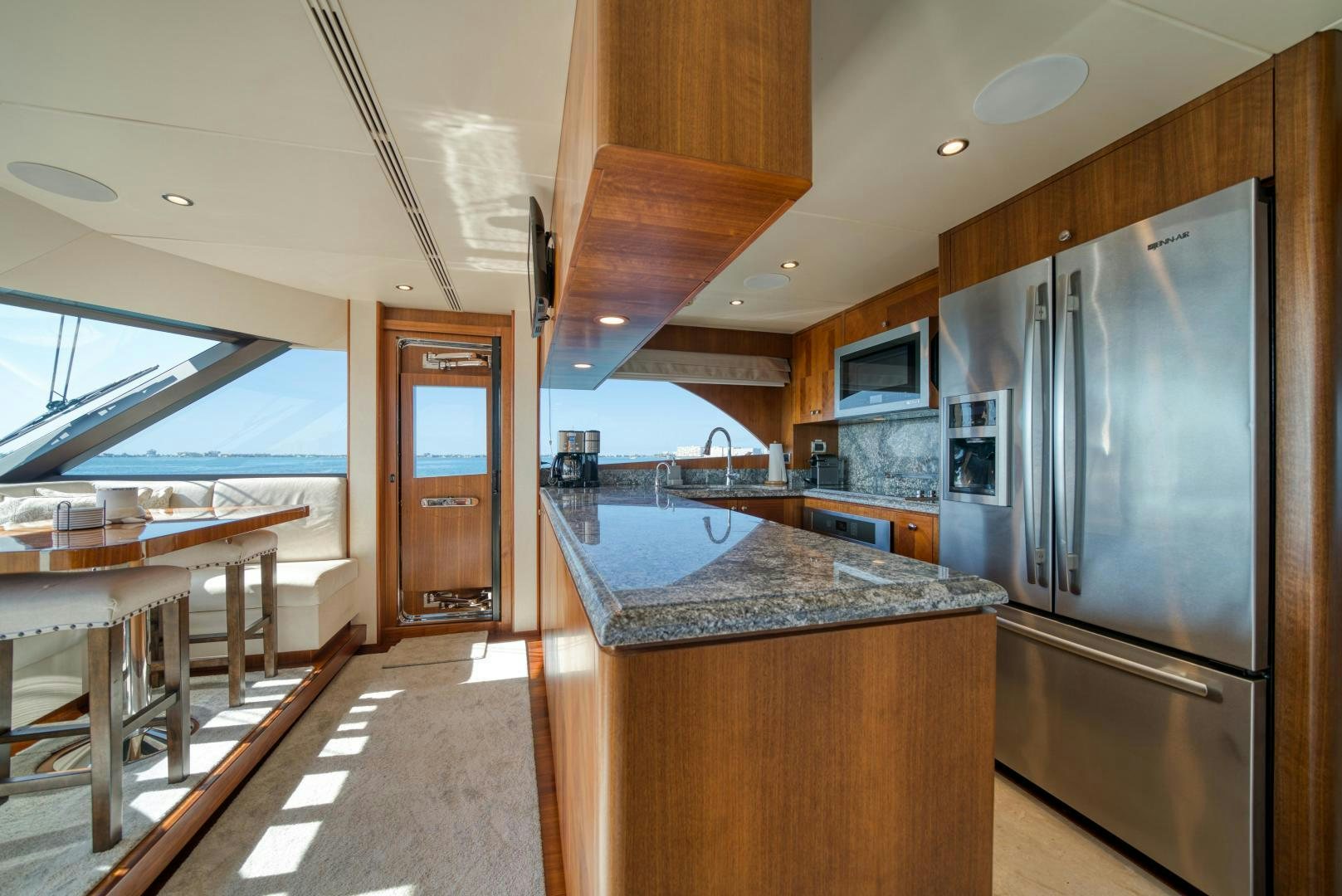 a kitchen with a stainless steel refrigerator aboard SANCTUARY Yacht for Sale