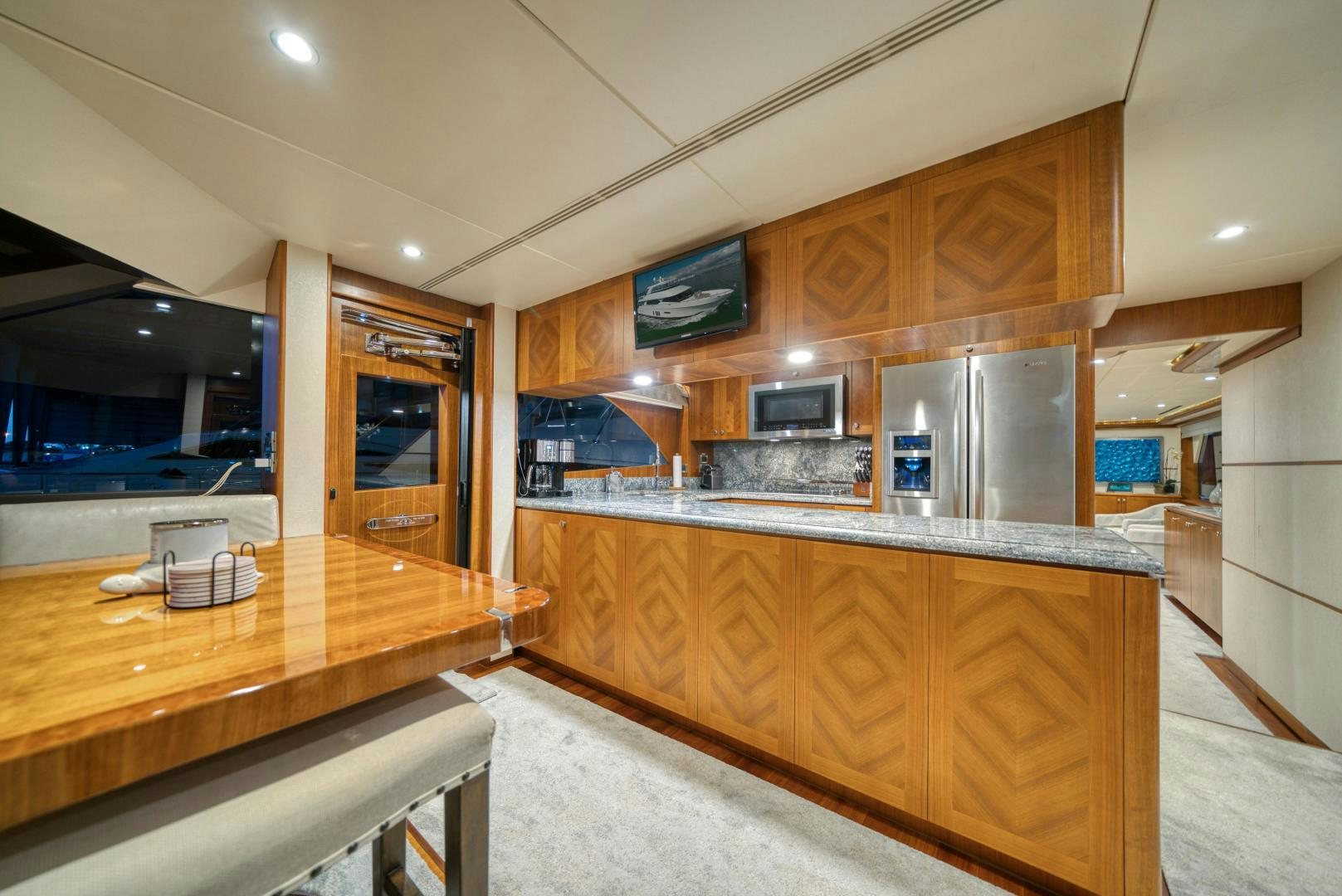 a kitchen with a bar and a bar aboard SANCTUARY Yacht for Sale