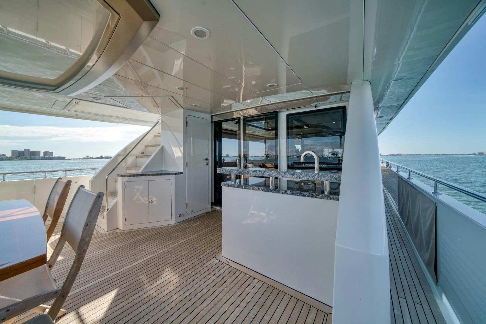 a room with a large window and a table and chairs aboard SANCTUARY Yacht for Sale