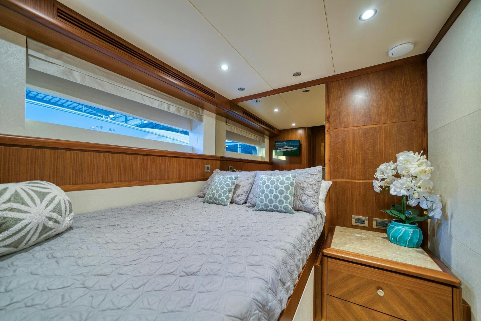 a bed with a white bed spread aboard SANCTUARY Yacht for Sale