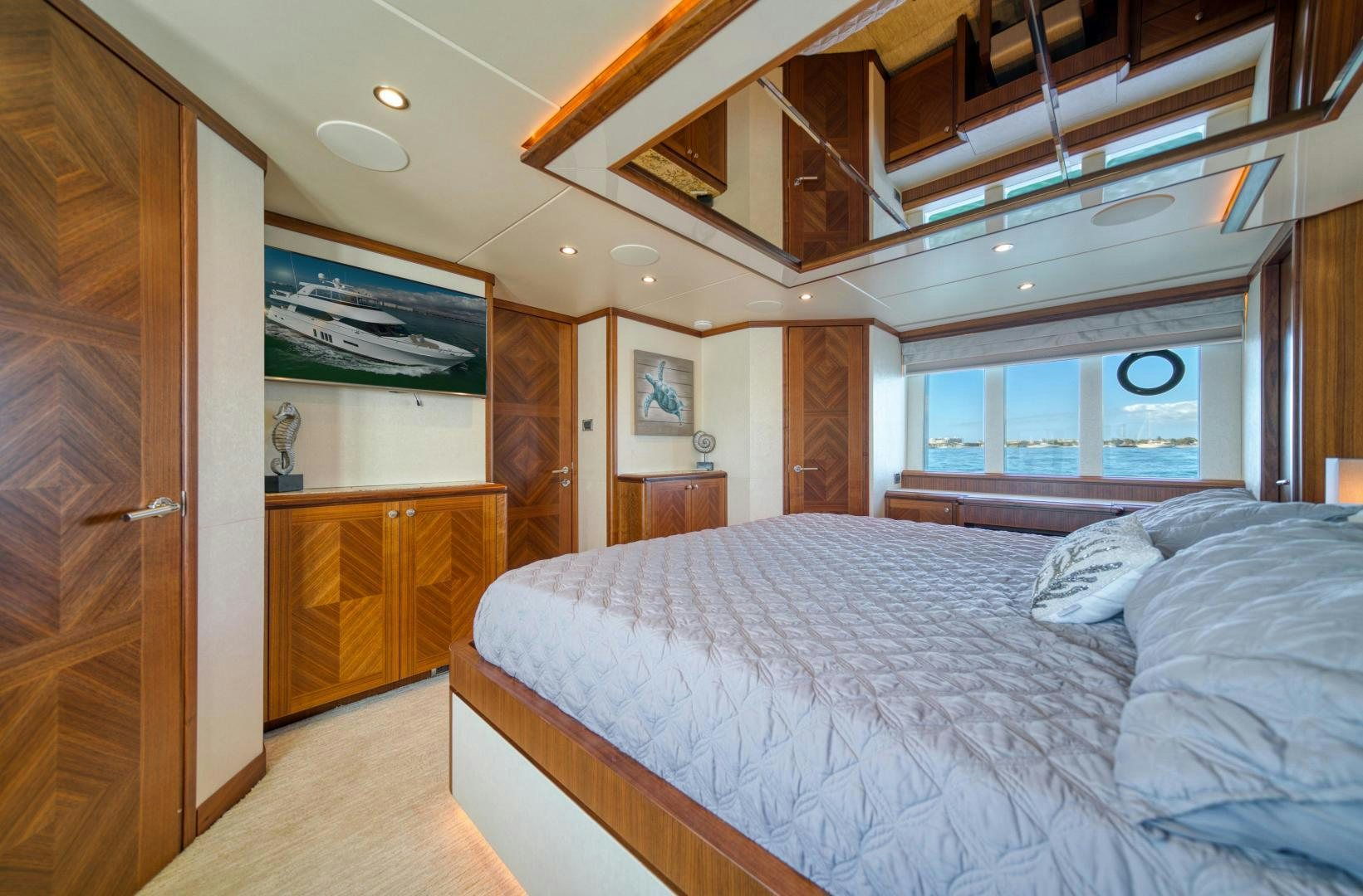 a bedroom with a bed and a wood door aboard SANCTUARY Yacht for Sale