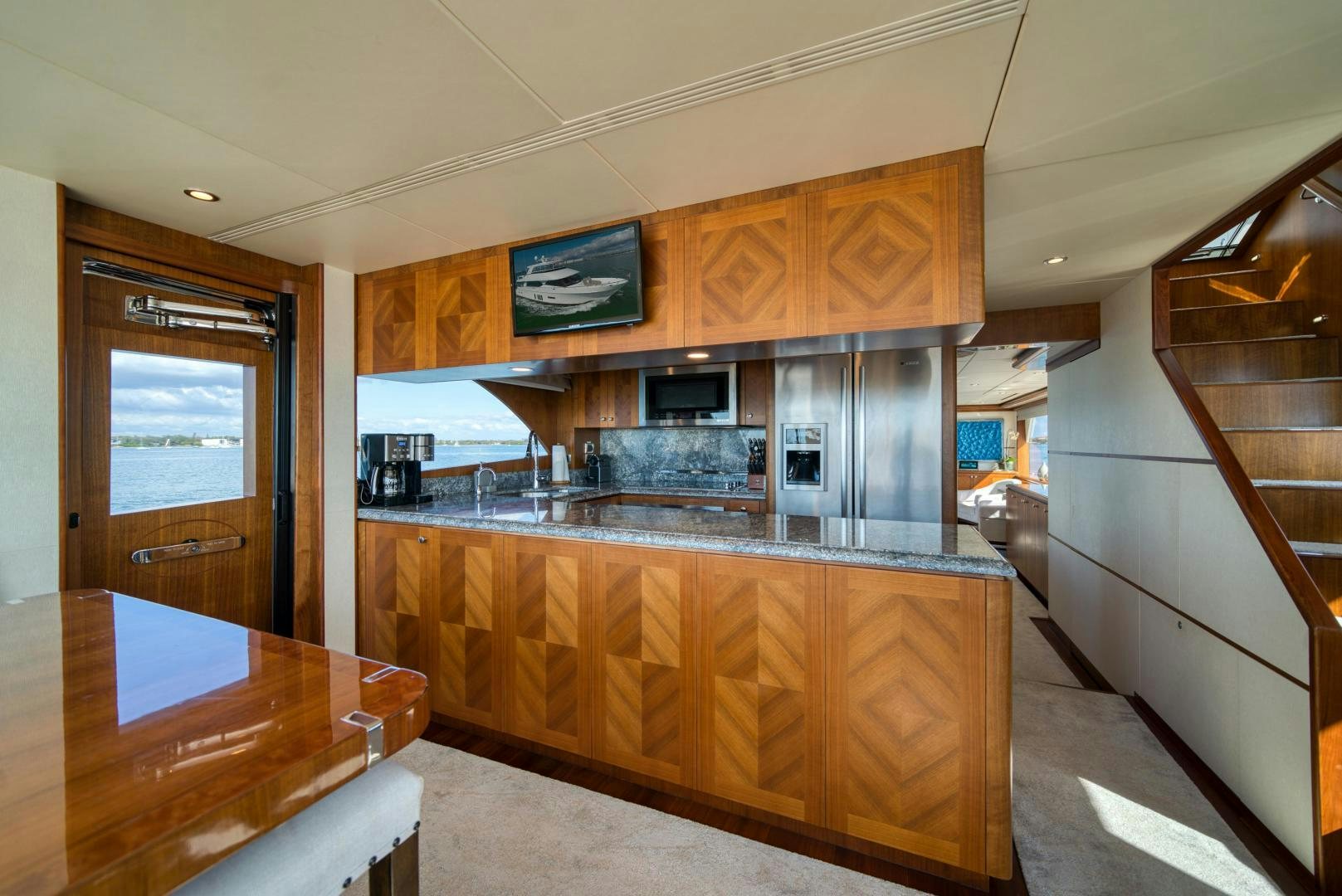 a kitchen with wooden cabinets aboard SANCTUARY Yacht for Sale