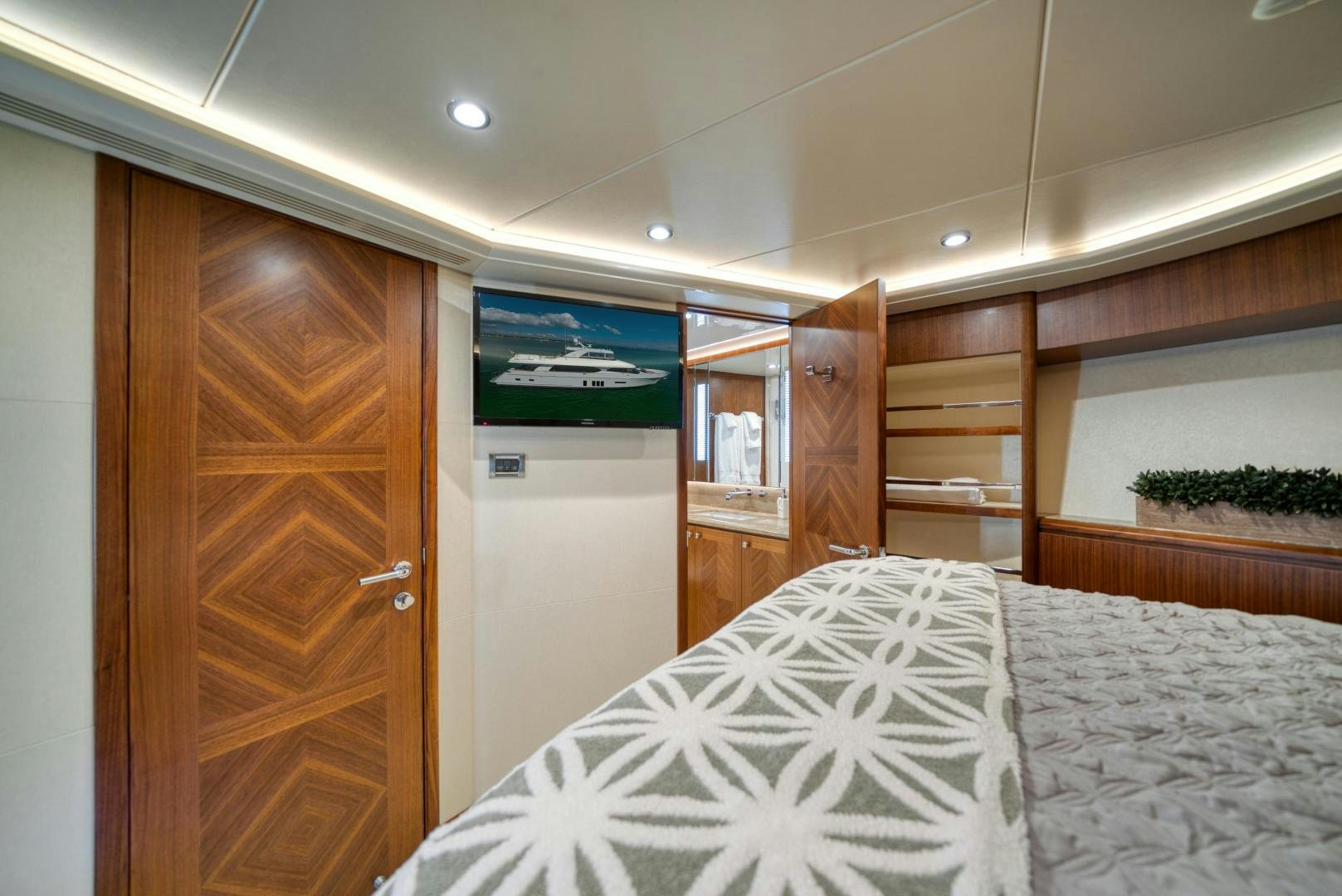 a bedroom with a bed and closet aboard SANCTUARY Yacht for Sale