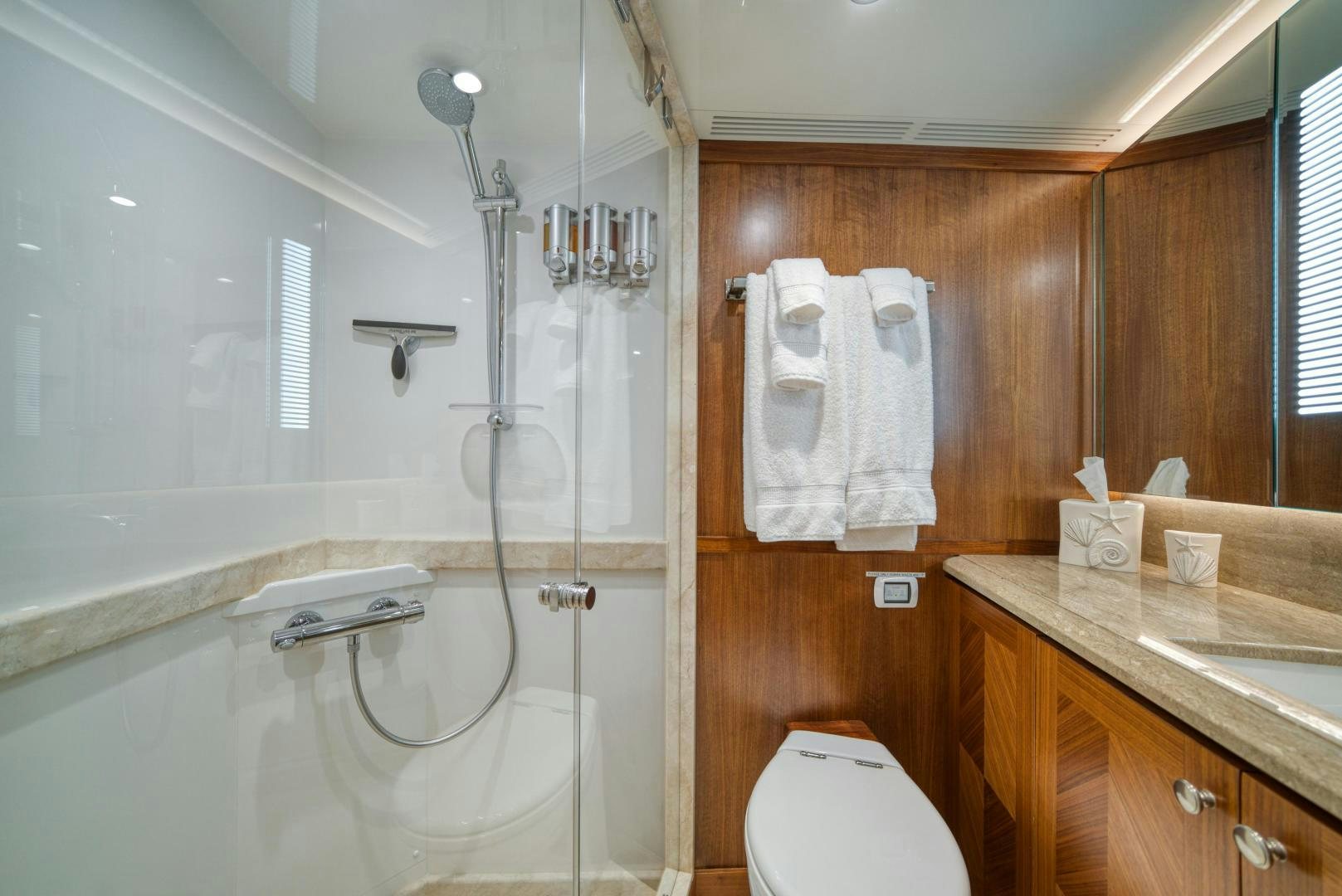 a bathroom with a shower sink and toilet aboard SANCTUARY Yacht for Sale