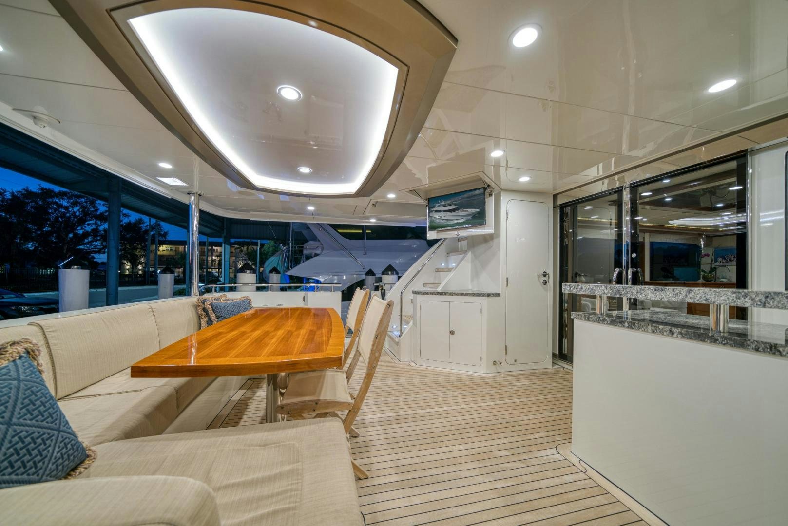a room with a wood floor and a large window with a view of the city aboard SANCTUARY Yacht for Sale