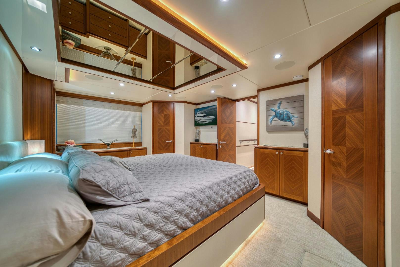a bedroom with a bed and a wood door aboard SANCTUARY Yacht for Sale