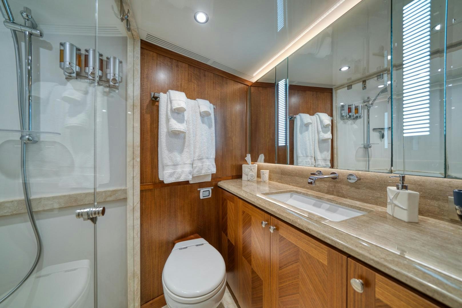 a bathroom with a glass shower aboard SANCTUARY Yacht for Sale