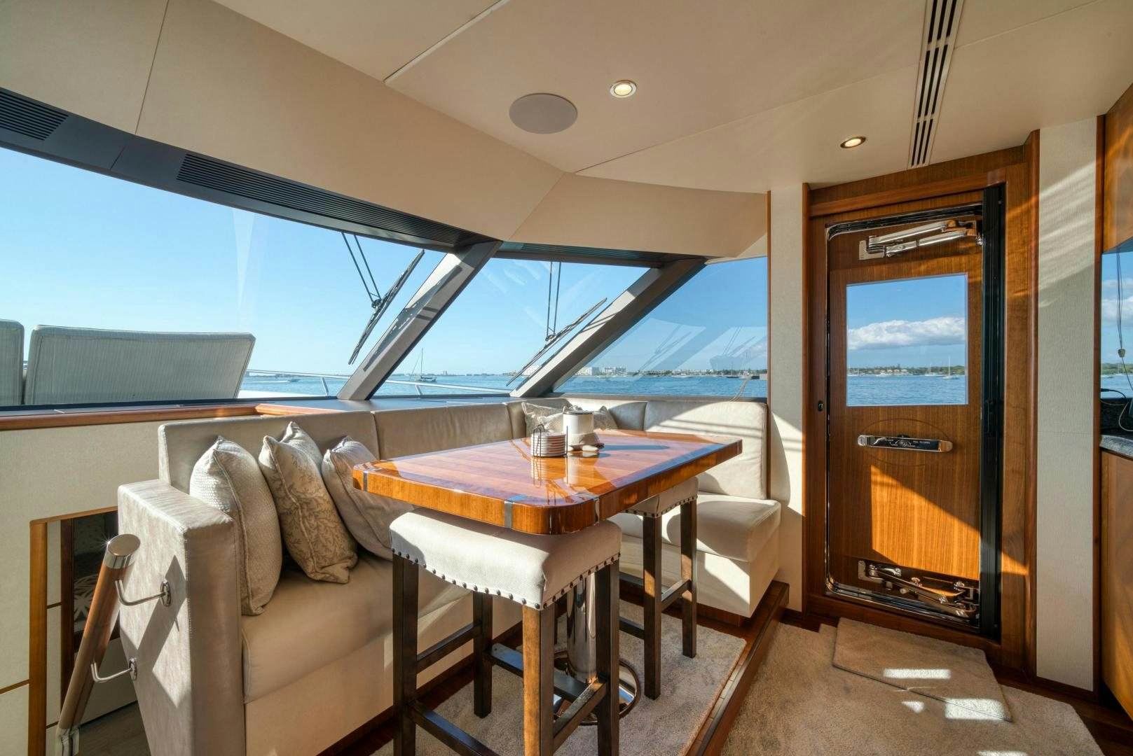 a living room with a table and a tv aboard SANCTUARY Yacht for Sale