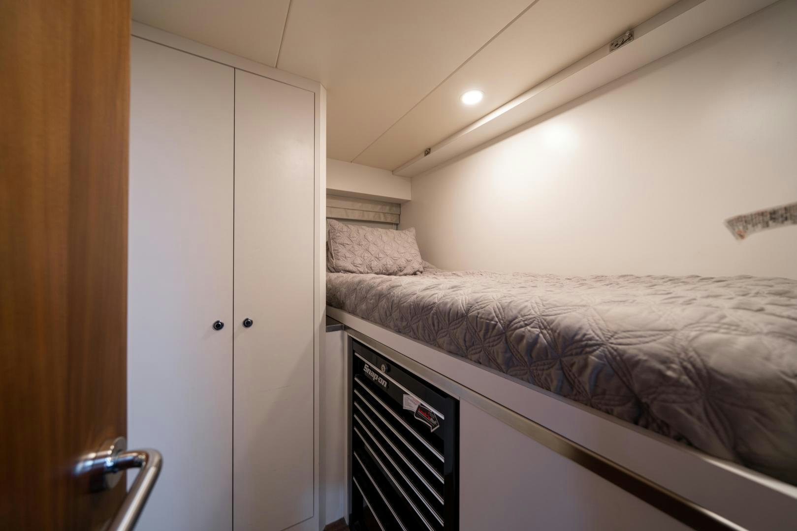 a bedroom with a bed and a microwave aboard SANCTUARY Yacht for Sale
