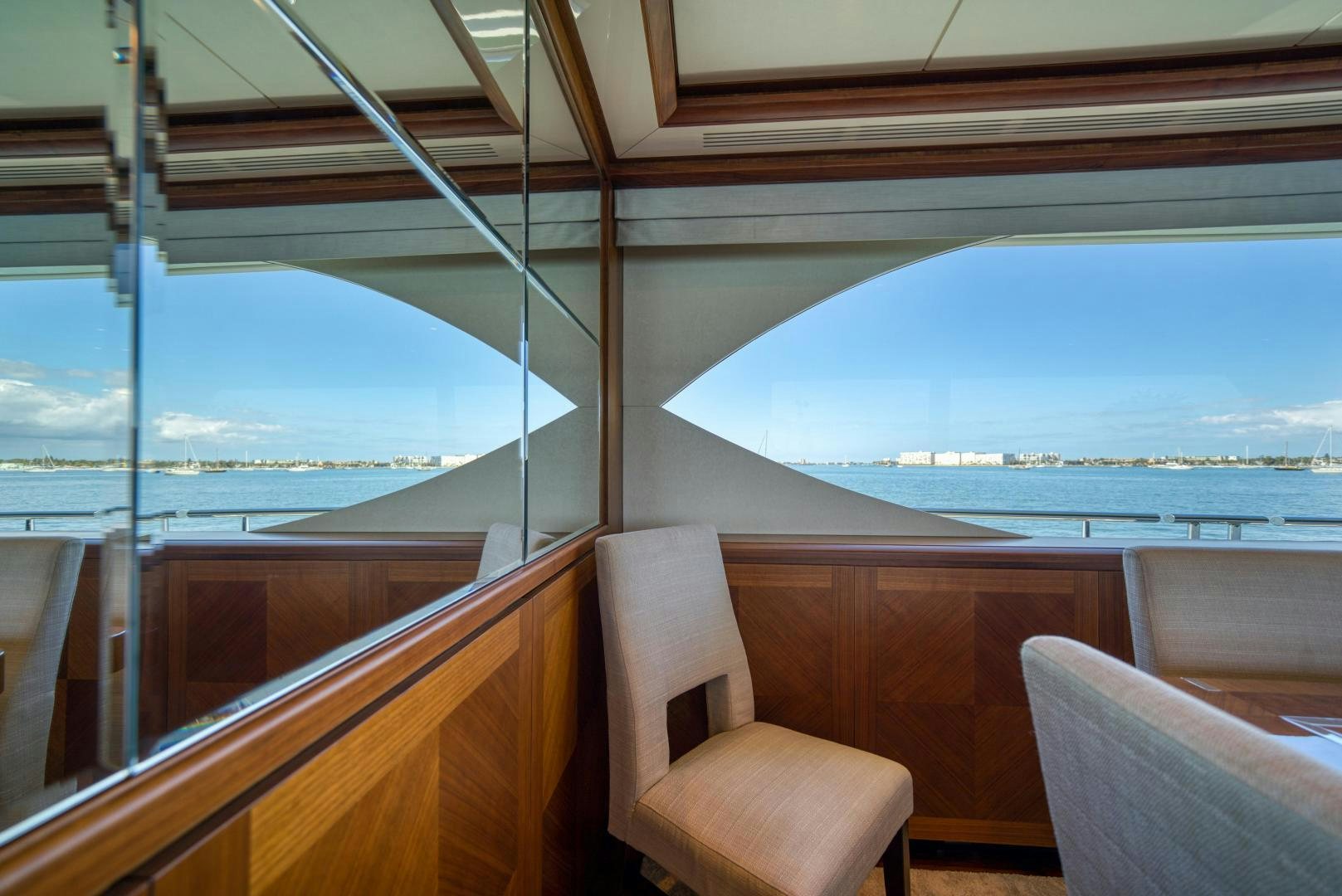 a room with a view of the ocean and a beach aboard SANCTUARY Yacht for Sale