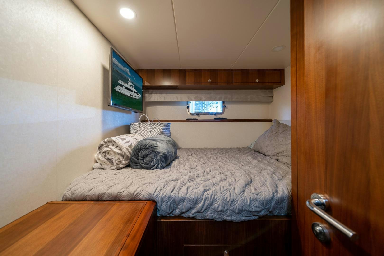 a bed with a television on the wall aboard SANCTUARY Yacht for Sale