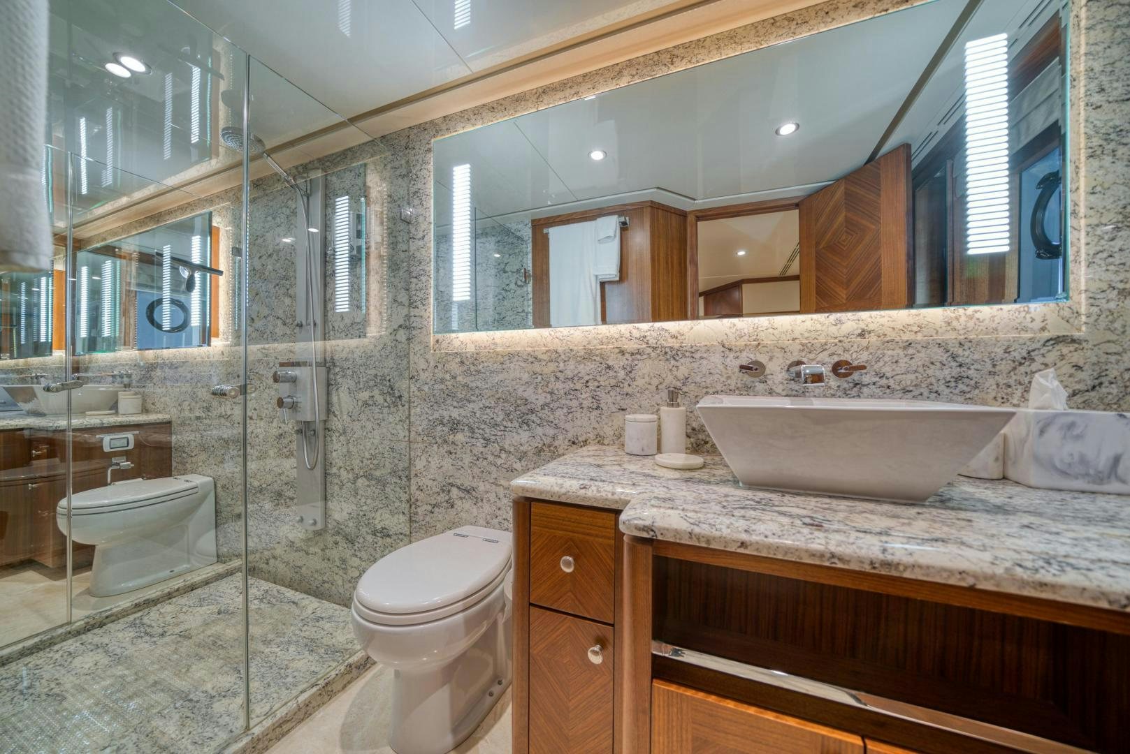 a bathroom with a glass shower aboard SANCTUARY Yacht for Sale