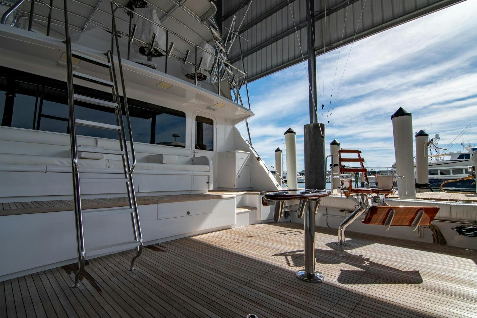 a deck with a table and chairs aboard CROUPIER Yacht for Sale