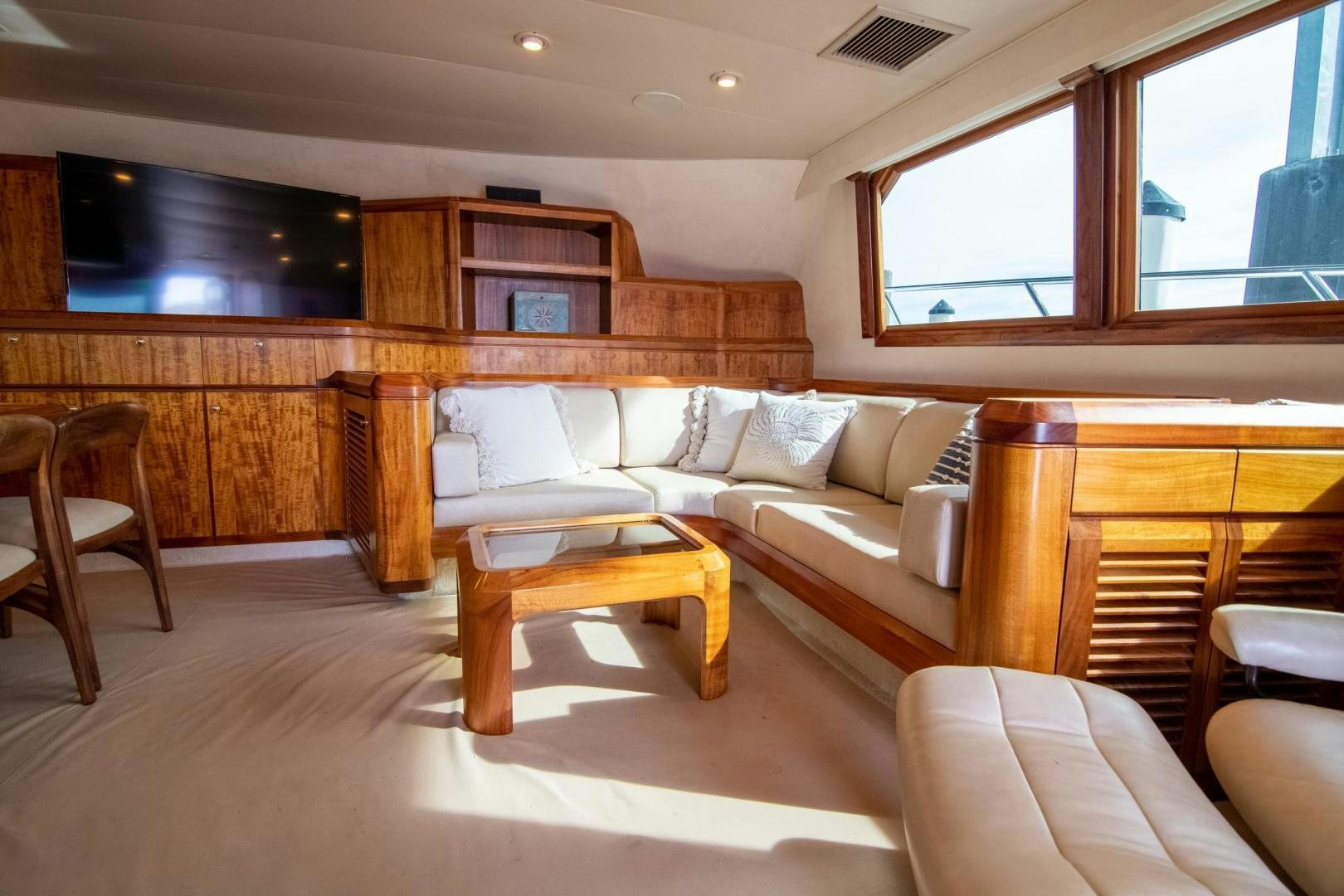 a living room with a couch and a coffee table aboard CROUPIER Yacht for Sale