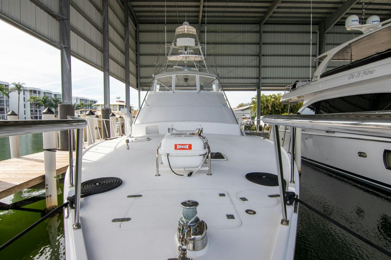 a white table with a white table and a white table with a red and black table and chairs aboard CROUPIER Yacht for Sale